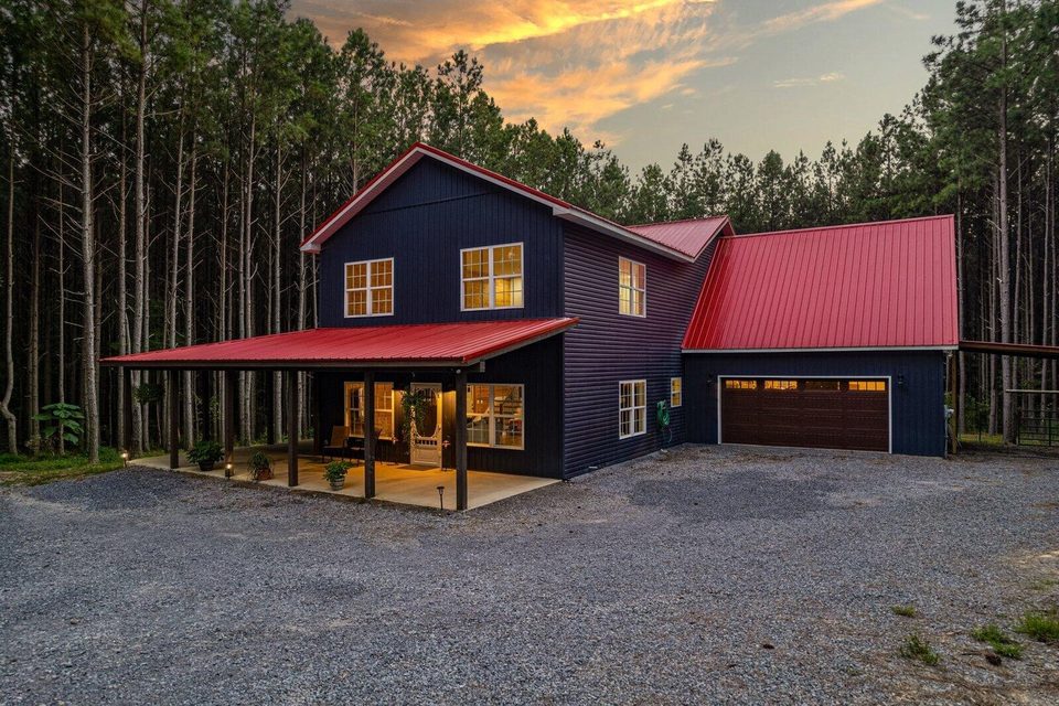 The main house and detached garage at 1194 Horseshoe Road, a 13 acre wooded property on Signal Mountain, Tennessee