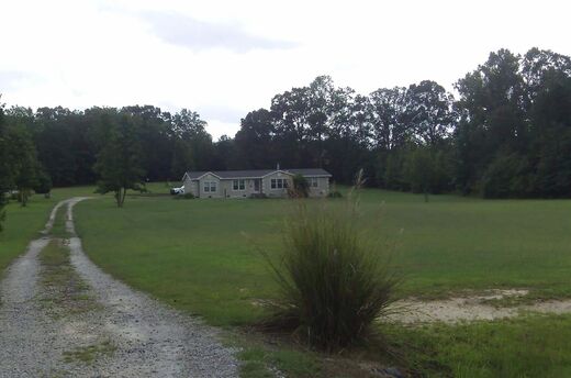 Open acreage with a gravel drive, representative of the team's land listings