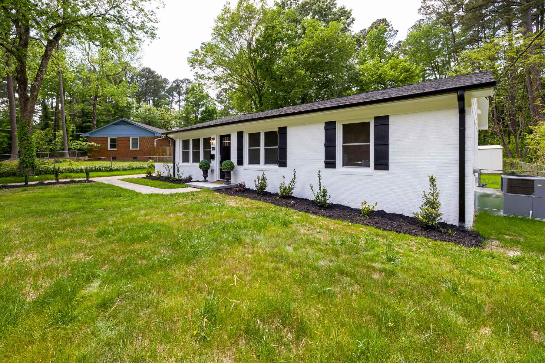Brick ranch home with a wide front lawn