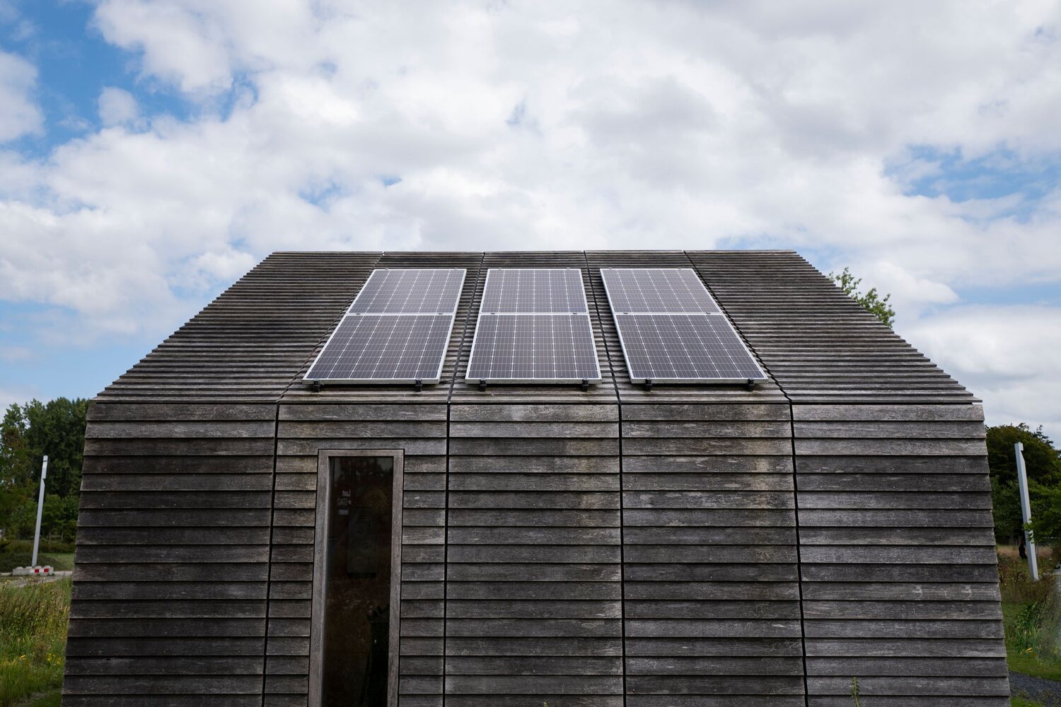 An off-grid cabin with solar panels mounted across its roof