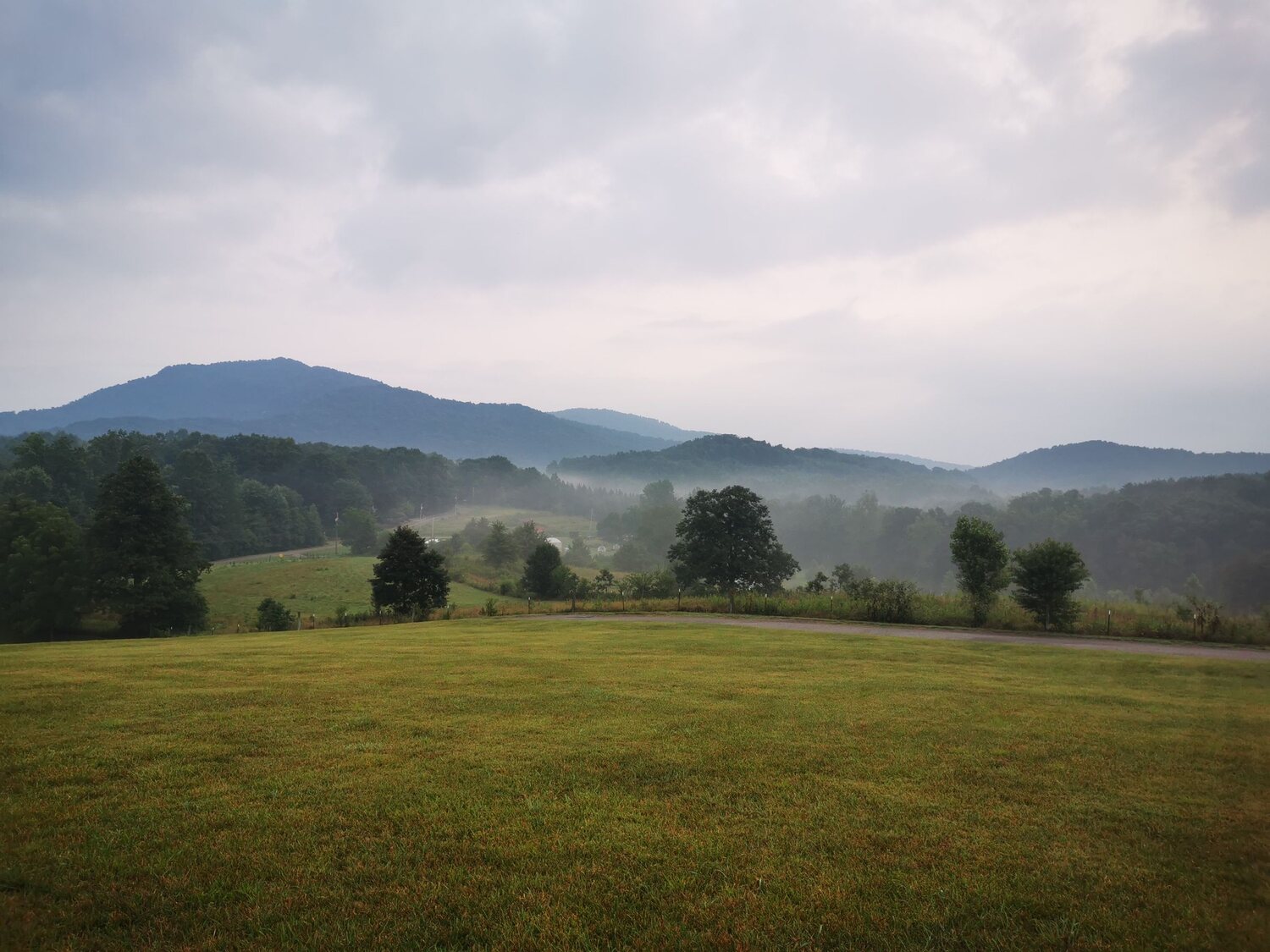 Rolling pasture with misty mountains behind, land suited to retiring in Tennessee