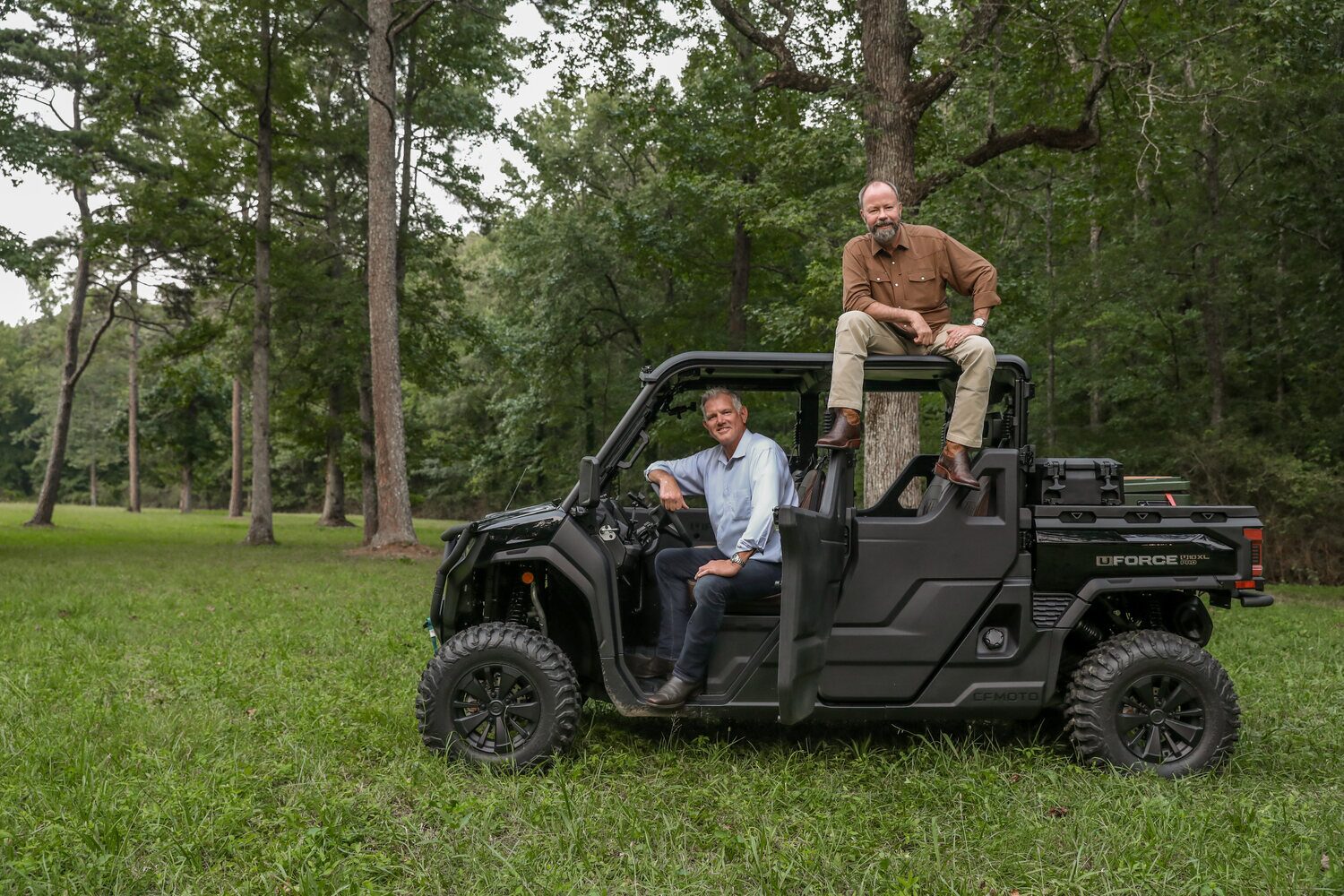Geoff Ramsey and Geoff Hurdle touring a land parcel by utility vehicle